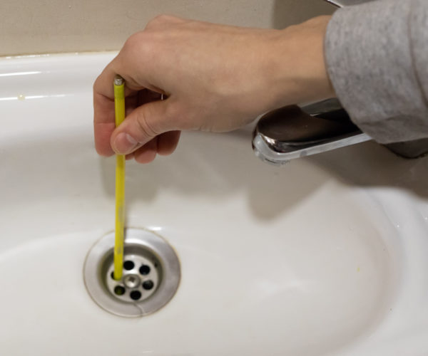 cleaning the drain of the sink